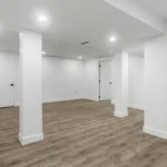Close-up of a light wood-look SPC flooring in a modern basement room