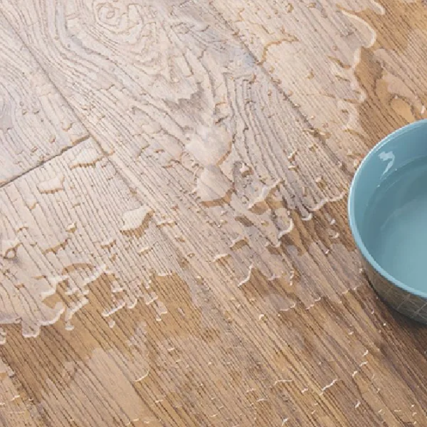 SPC flooring waterproof surface with spilled water drops.