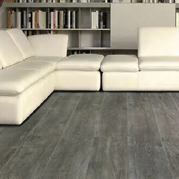 SPC flooring with a dark gray, charcoal wood grain in a modern living room