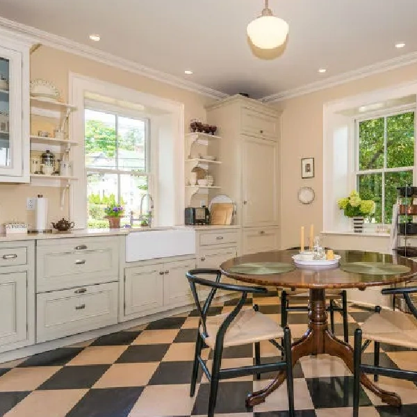 Black and tan checkerboard linoleum flooring in a kitchen.