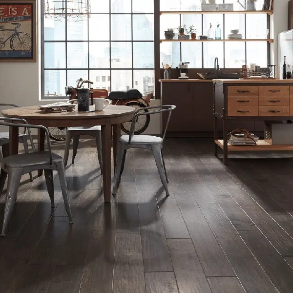 Dark brown, wide-plank hardwood flooring in an industrial loft-style dining
