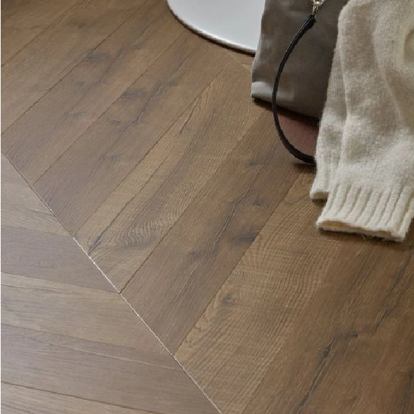Close-up of brown vinyl flooring in a chevron pattern.