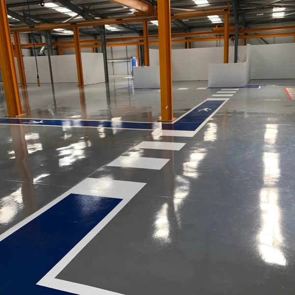 Glossy industrial epoxy flooring with directional markings