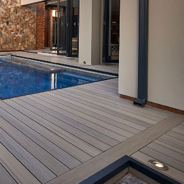 Gray striped hollow WPC decking around a modern outdoor pool