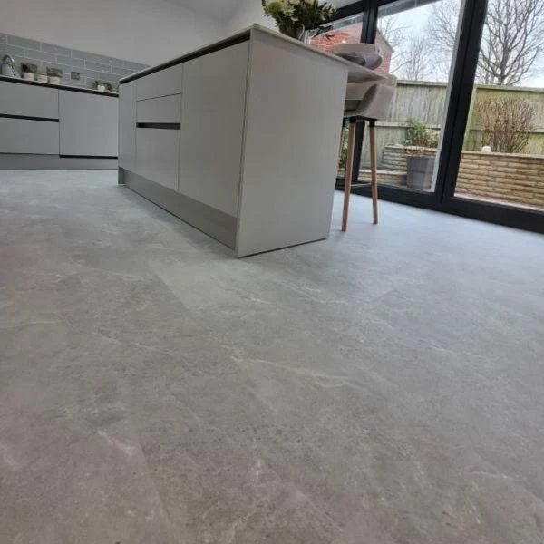 Grey marble-effect vinyl click flooring in a modern kitchen
