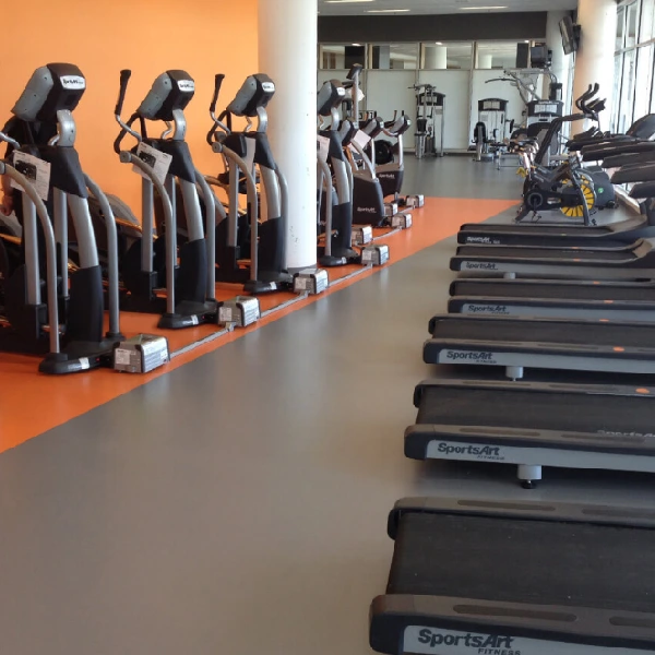 Gym with orange and gray rubber fitness flooring.