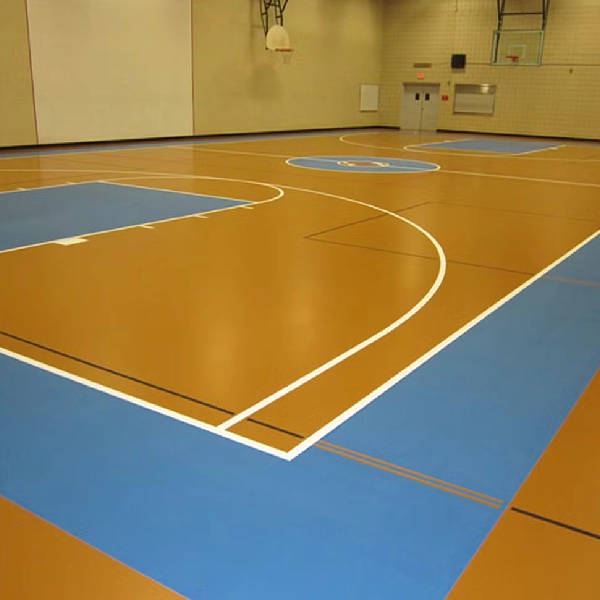 Large sports court with light brown and blue linoleum flooring