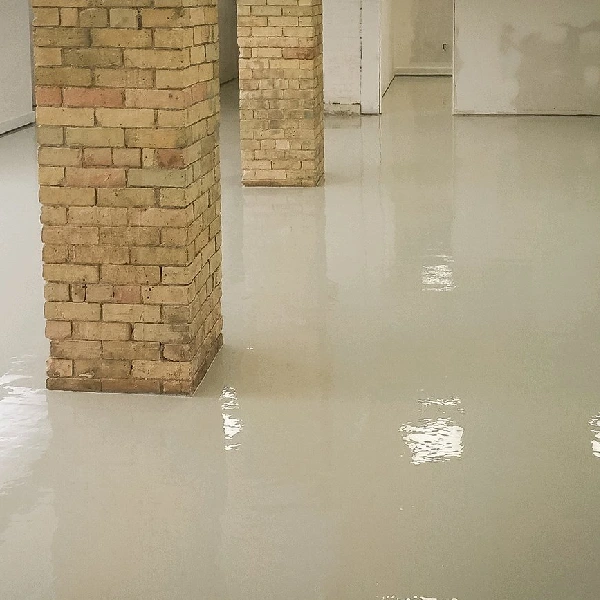 Light gray epoxy floor and brick support columns.