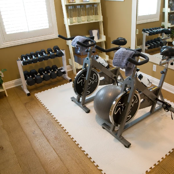 Small area of light white interlocking foam gym floor tiles