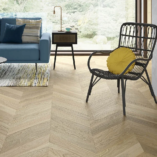 Solid wood flooring in a light oak chevron pattern in a living room