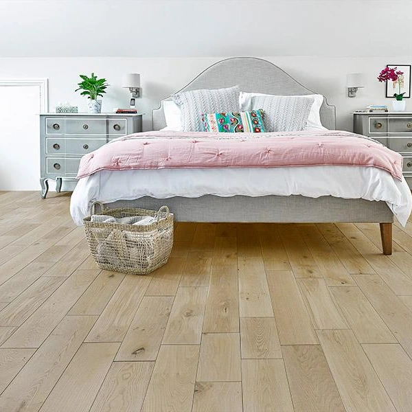 Solid wood flooring with light blonde oak planks in a bedroom