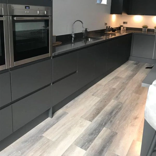 Washed grey wood-effect vinyl click flooring in a contemporary kitchen