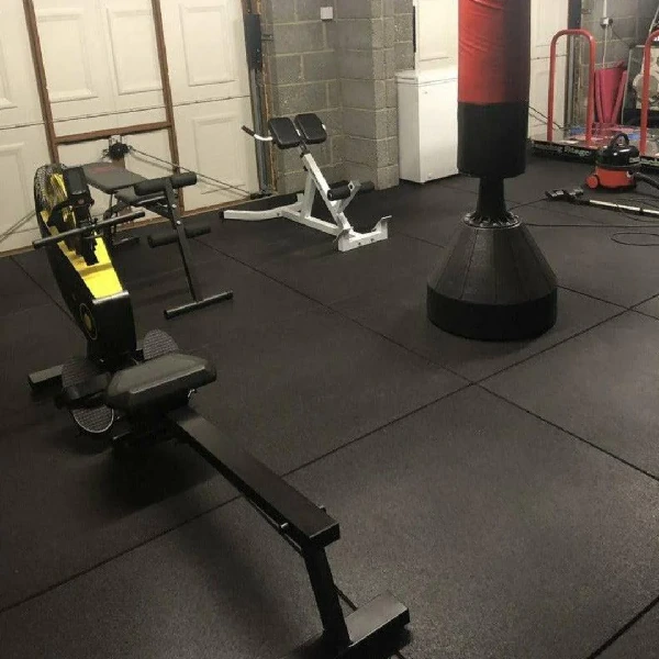 black rubber gym flooring covering the entirety of a home gym space