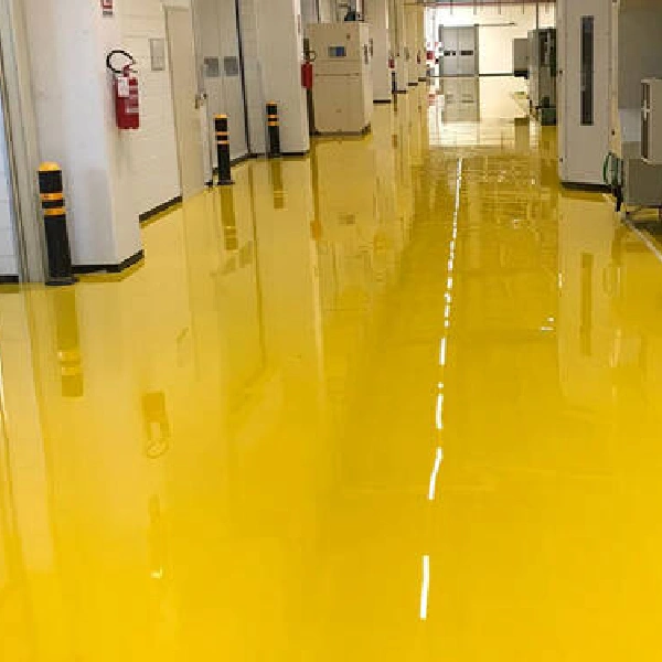 bright yellow epoxy painting with a reflective white dashed centerline in an industrial hallway