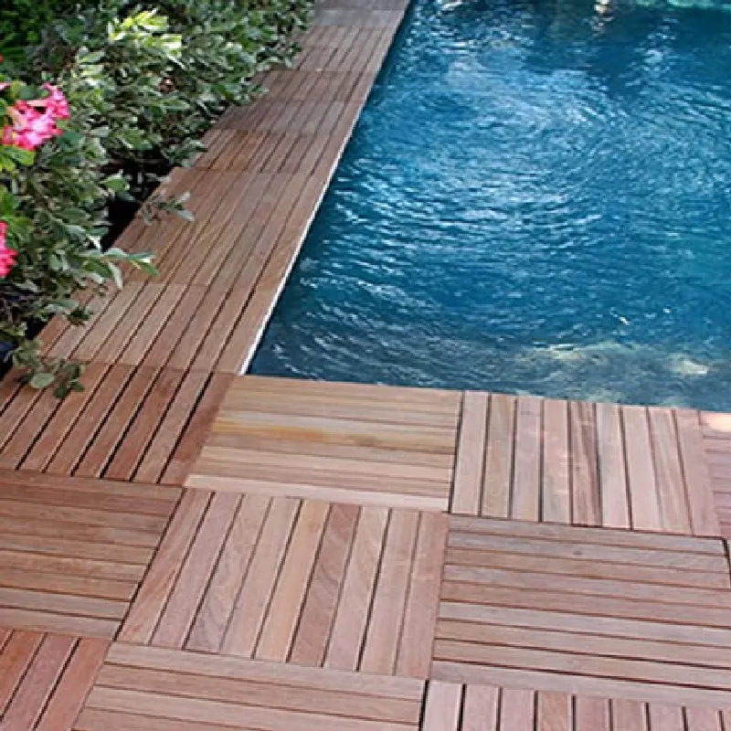brown WPC decking tiles surrounding the edge of a swimming pool.
