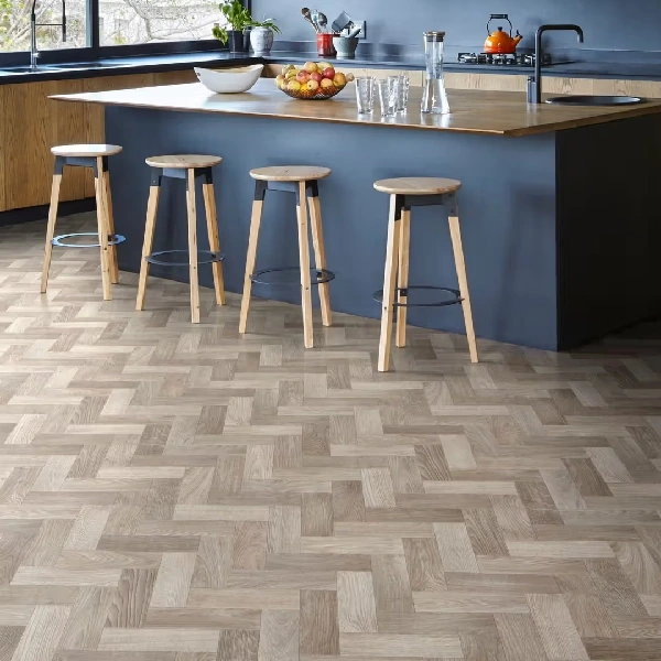 brown wood-look vinyl flooring in a herringbone pattern in a modern kitchen