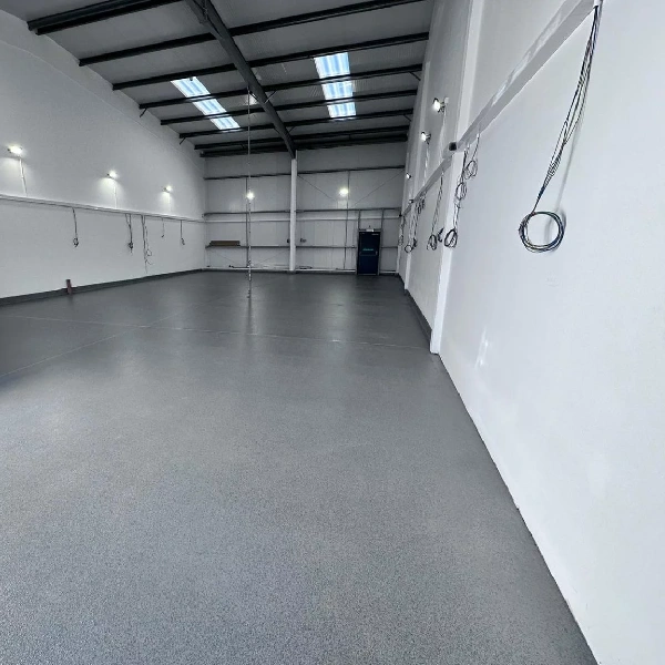 grey MMA resin floor coating in a large, clean, empty warehouse