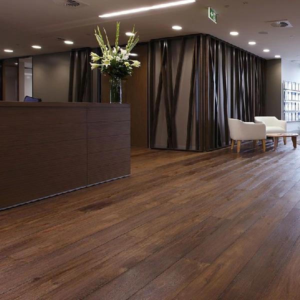 reddish-brown laminate flooring in a modern office reception area.