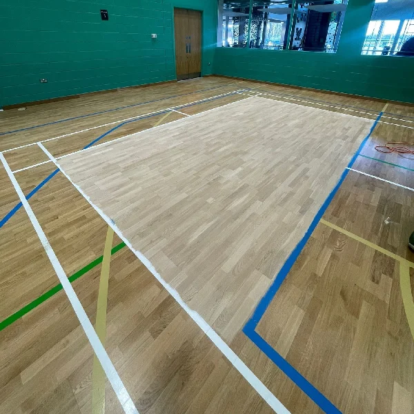 wood patch installed on multi-sport gym floor.
