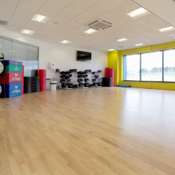 yoga studio with wood flooring and fitness gear.