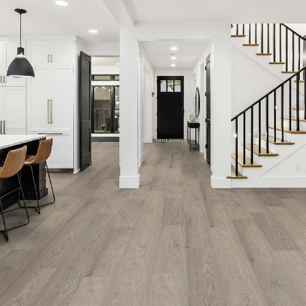 SPC flooring with wide, light gray-taupe planks